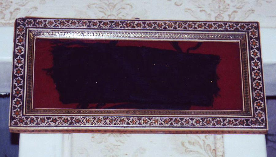 A framed piece of the kiswah covering the Kaaba, presented in the home of a Shiraz, 2001.