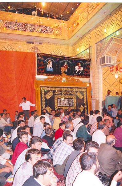 The ceremonial hall in the imamzadeh of Sayyid Muhammad ibn Ali ibn Husayn, decorated with wall hangings for the mowludi of Imam Husayn, 2001.