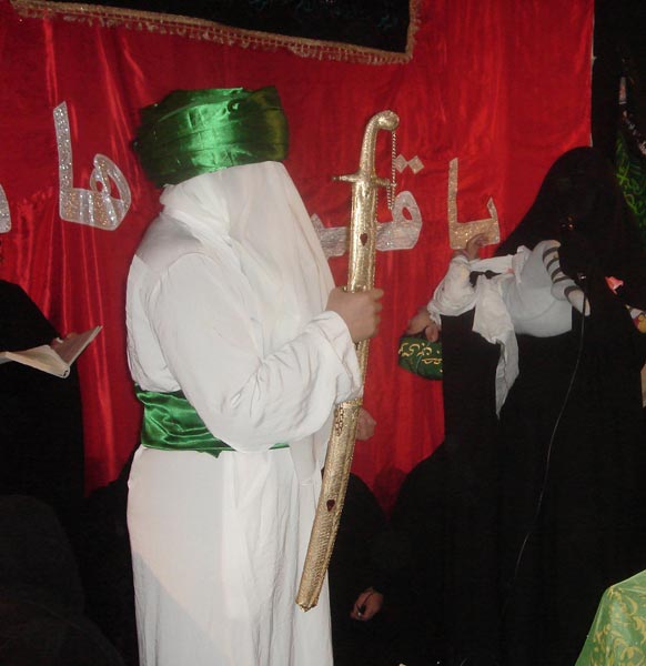 Shia women of Iraqi origin performing a theatrical representation in which Imam Husayn stand by a prop representing the cradle of his baby son Ali Asghar. Oslo 2009.