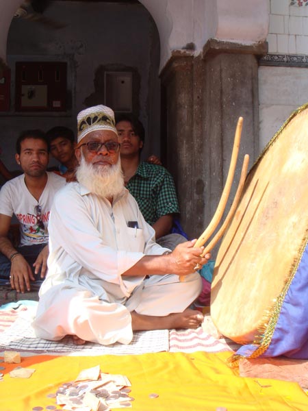 A sajjada nishin of Haider Shaikh beating drums and collecting offerings from pilgrims at Malerkotla 2011 -- Yogesh Snehi