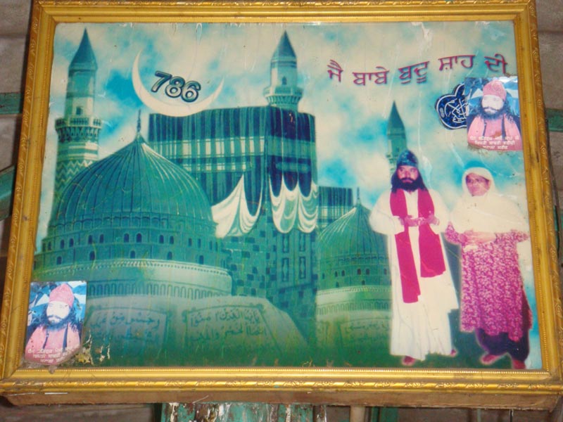 A printed poster of Mecca and Medina shrines along with the images of Saint Buddhu Shah and his wife 2011 -- Yogesh Snehi