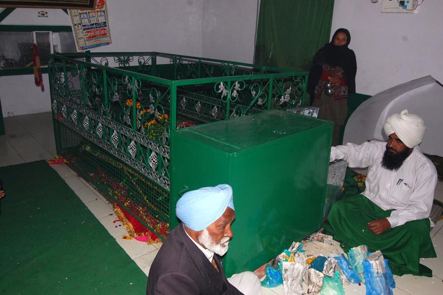 The grave of Saint Haji Rattan being attended by devotees 2011 -- Yogesh Snehi