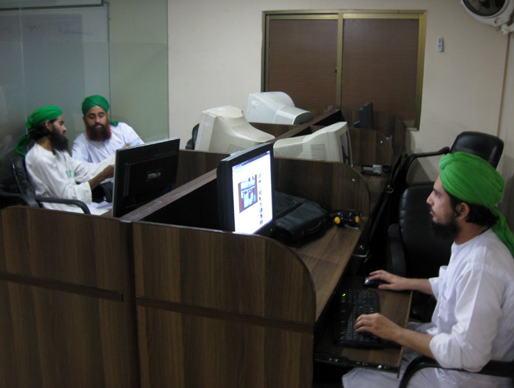 Staff working in a small room of the I.T. Majlis located inside the Faizan-e-Madina.