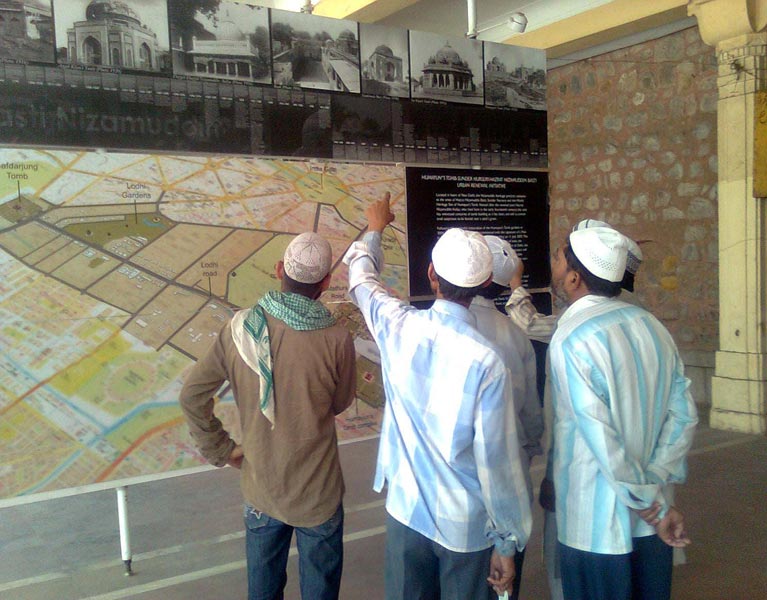 Local residents watching a panels on heritage restoration, displayed in an exhibition at Urs mahal, organised by the Aga Khan Trust for Culture. 2009. Photograph by Yousuf Saeed